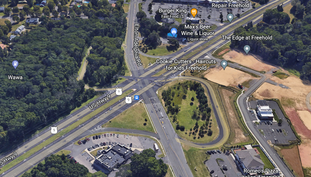 The image shows an aerial photo of the US-9 and Adelphia Road intersection.